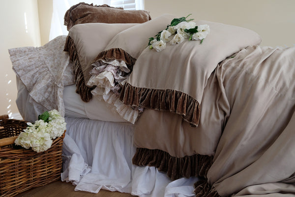 Woman relaxing on soft cotton poplin sheets made in beautiful linen bedding by Linen Salvage California 